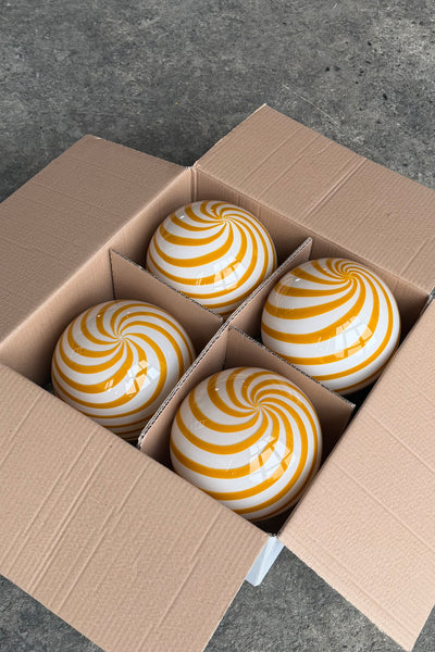 Murano pendant in yellow/white swirl pattern presented in a box with squares and smooth surfaces