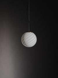Murano pendant in white with swirl pattern, hanging in a dark frame that highlights the lamp's elegant shape